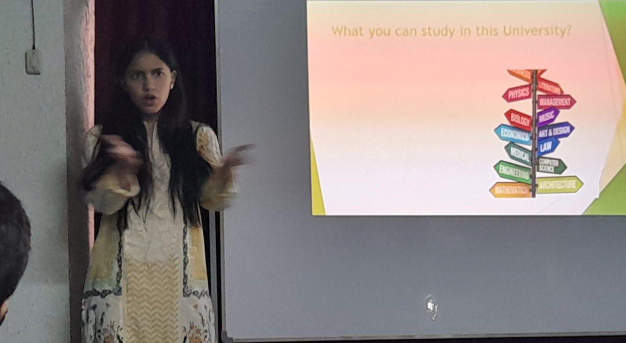 Iman giving presentation -  test on screen: What you can study in this university