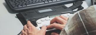 A blind person using a braille terminal, an assistive technology device that converts digital text into Braille characters. Photo:Sigmund/Unsplash
